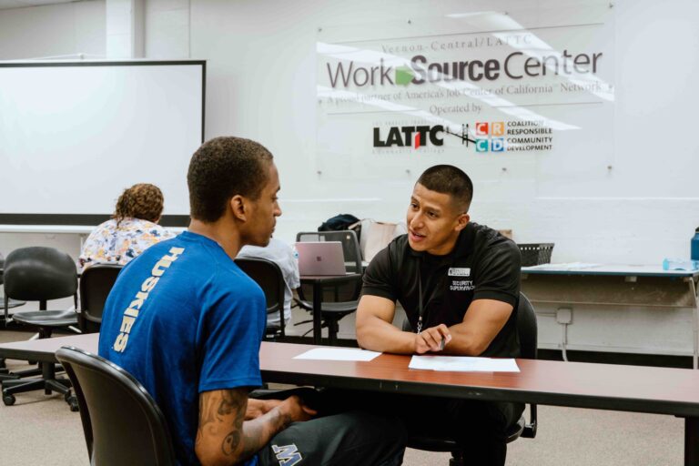 A counselor meeting with a client inside the Los Angeles WorkSource Center, showcasing local workforce development and community job resources.