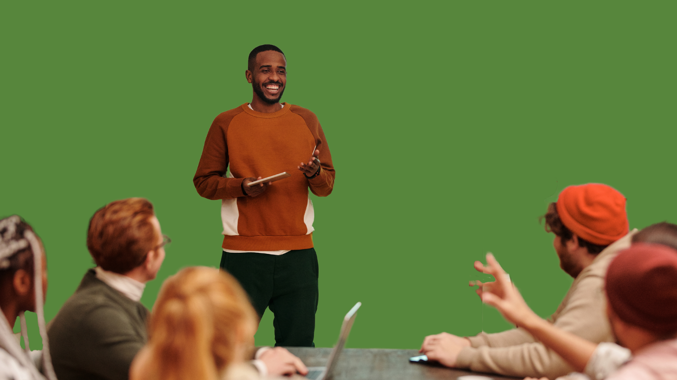 A confident workshop presenter leading an intimate, interactive discussion with a group of attentive professionals in a collaborative setting.